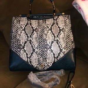 Blue, Gray and black snake skin print with gold handles and shoulder strap.